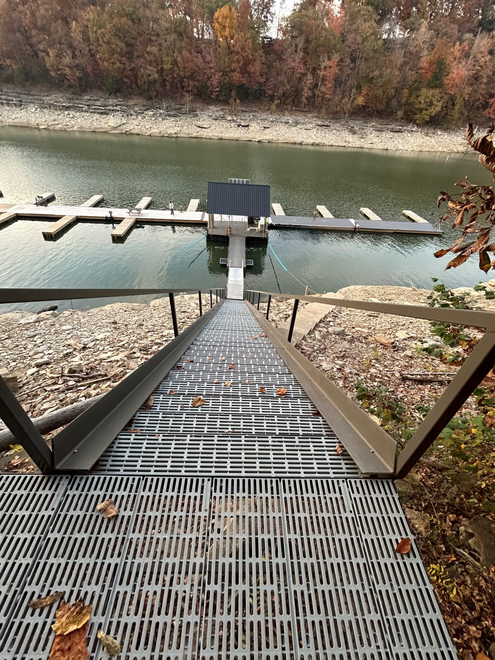 Metal staircase leading to a lakeside dock.