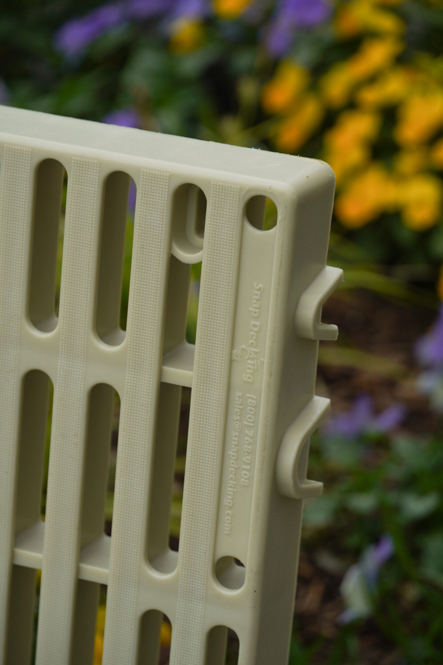 Plastic grid with colorful flowers background.