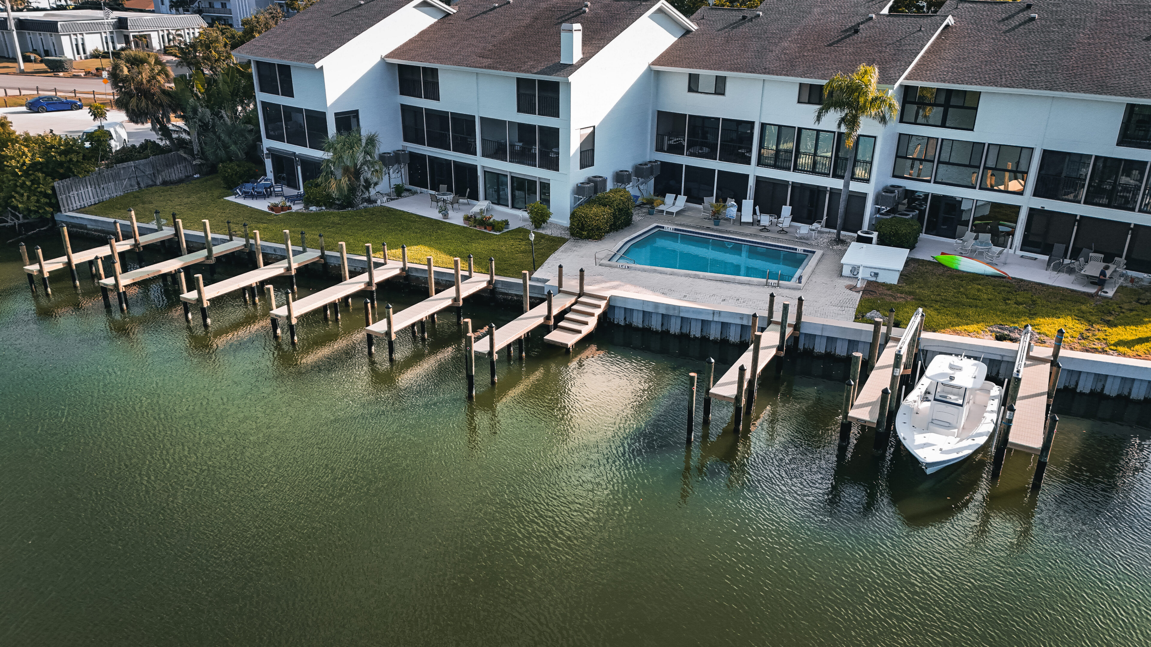 Waterfront homes with docks and a pool.