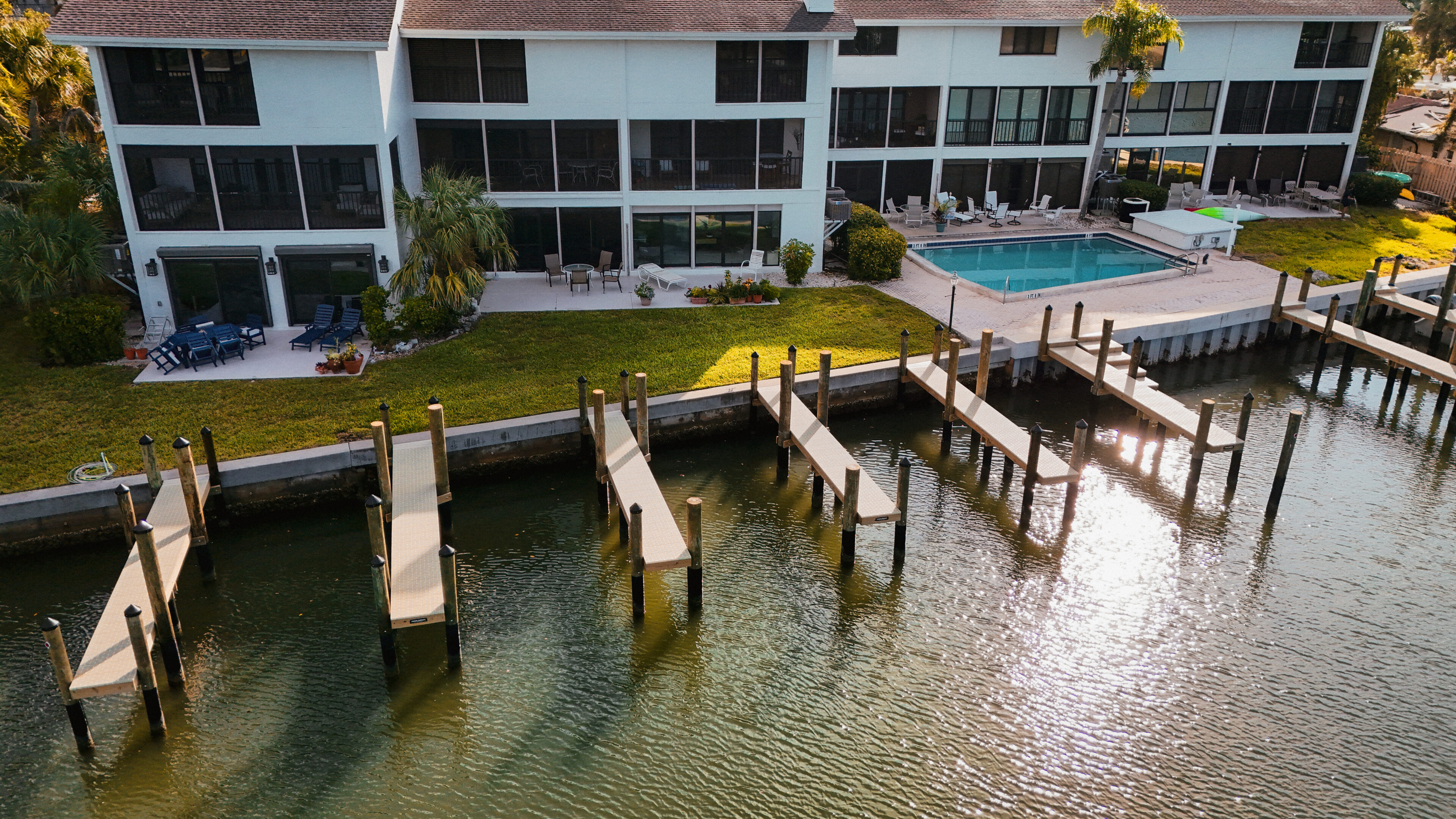 Waterfront house with docks and swimming pool.
